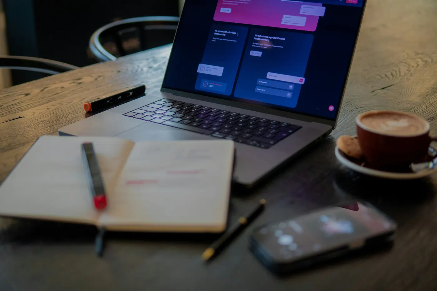 Laptop and notebook on a table in a coworking workspace